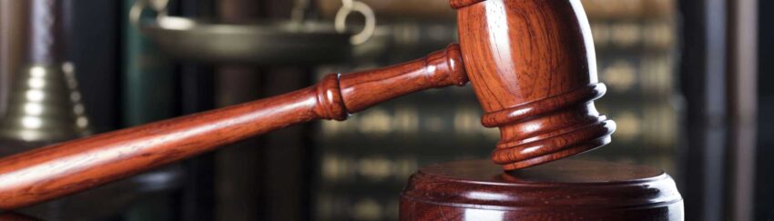 A gavel with books in the background that is used in cases of defendants who posted bail
