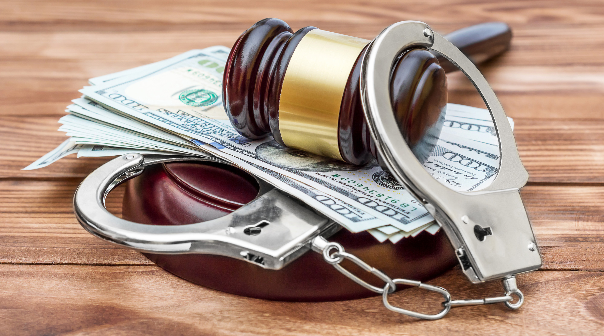 Handcuffs, money and a gavel used to represent a bail bond