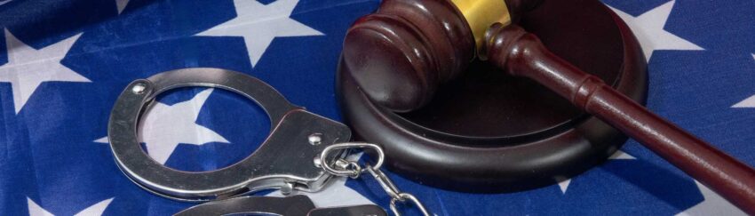 A gavel and handcuffs on a table in Fort Bend County, TX, that was used in a case where the defendant had a bail bondsman