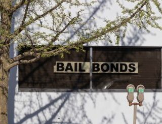 building displaying a sign for Bail Bonds and Bail Bond Loans in Harrisburg, TX
