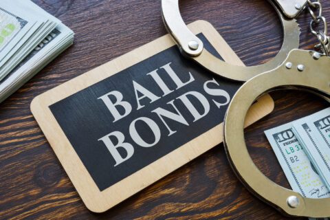 Bail bonds sign with handcuffs and cash in Conroe