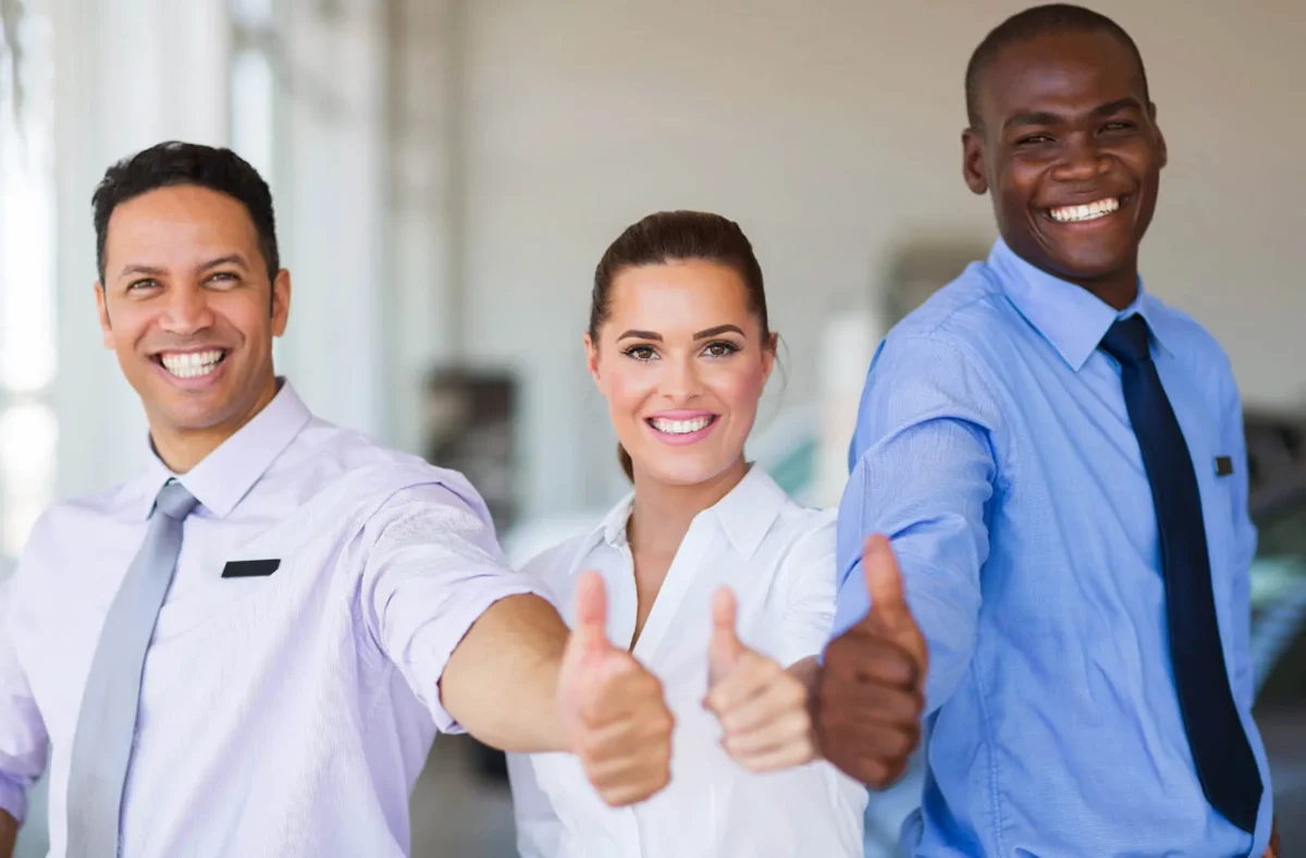 Office workers giving a thumbs up at company in Clear Lake that uses surety bonds