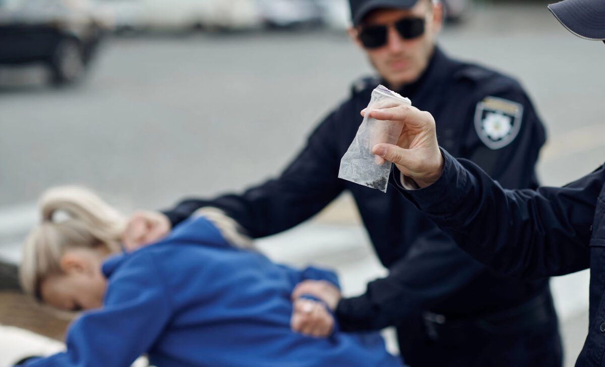 Police officer making a misdemeanor arrest before bail in Midtown